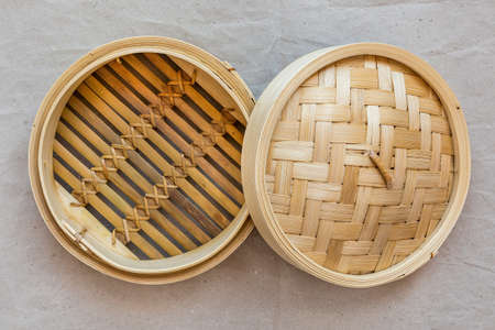 Bamboo steamer set, chinese kitchenware on grey paper.の写真素材