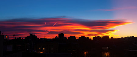 Amazing sunset with orange, pink and red stratus clouds over the city. Background for forecast and...