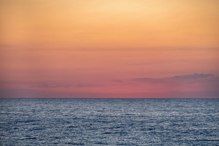 Blue sea with orange yellow sky at the dawn