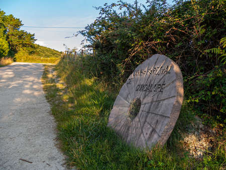 Round stone like a wheel with the name of the hiking route Camino Forestal de Guadalupe.の写真素材