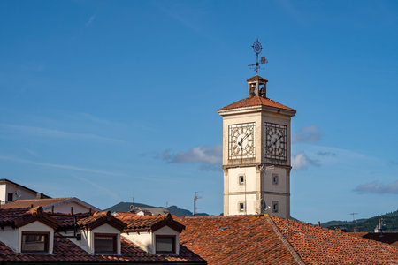 Tower of the old town hall with a clock in Guernica, Basque Country, Spain. Over the roofs view