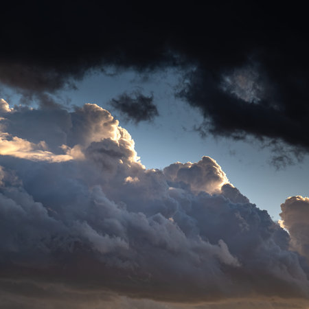 Confrontation of light and darkness. Clouds lighted with sun versus dark overhanging heavy clouds....