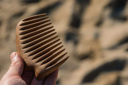 Handmade wooden comb for scalp massage and hair combing. Hair care concept.の写真素材