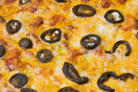 Close-up of pizza topped with olives and cheese.. Macro shot of delicious products.の写真素材