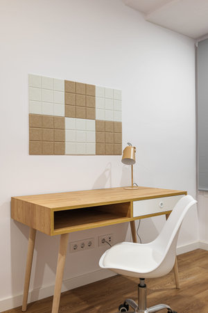 Stylish and minimalist room interior with modern comfortable workplace. Wooden table and floor with...