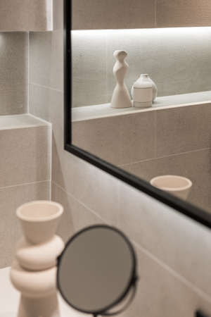 Modern bathroom interior with mirror and decorative elements in reflection. Minimalist style. Selective focusの写真素材