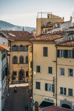 29 SEPTEMBER 2021, FLORENCIA, ITALY: Top view of a beautiful orange colored old tenement house with arches in Florence on a sunny warm summer day. Concept of beautiful old european architectureのeditorial素材