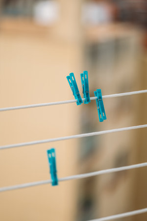 Blue Clothes Pins Are Hanging On A Clothes Lineの写真素材