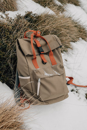 Discarded Backpack in Snow Indicates a Break in Hiking Journey