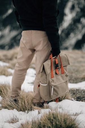 Back View of a Hiker with a Backpack on a Snowy Trailの写真素材
