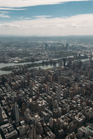 Aerial view of New York City with skyscrapers and river on a cloudy day