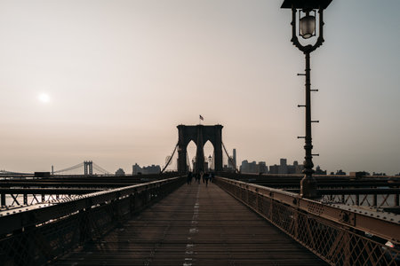 Panoramic view of Brooklyn Bridge at sunrise with a calm skylineの写真素材