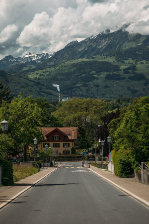 Scenic mountain road in Liechtenstein, surrounded by lush greenery and picturesque views. Ideal for a peaceful getawayの写真素材