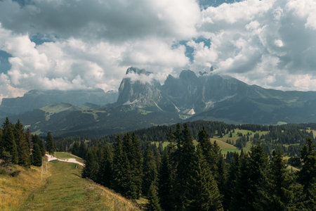 The View of the Dolomites is absolutely breathtaking and stunningly beautiful, set against vast cloudy skiesの写真素材