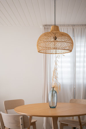Sophisticated and Stylish Minimalist Dining Room Featuring a Beautiful Woven Pendant Light