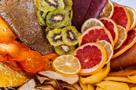 Close up of assorted dried fruits including kiwi citrus and pear creating a colorful organic arrangementの写真素材