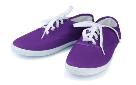 Purple sneakers on a white background の写真素材