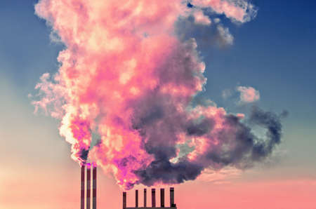 Chimney smoke at pink sunset skyの写真素材