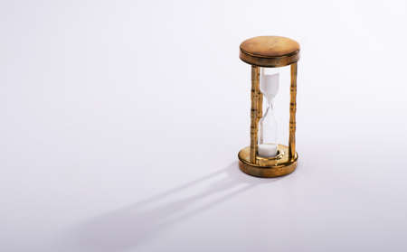 Vintage hourglass on gray background with long shadowの写真素材