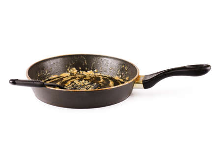Dirty frying pan after cooking isolated on white backgroundの写真素材