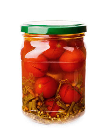 A glass jar of canned tomatoes isolated on white backgroundの写真素材