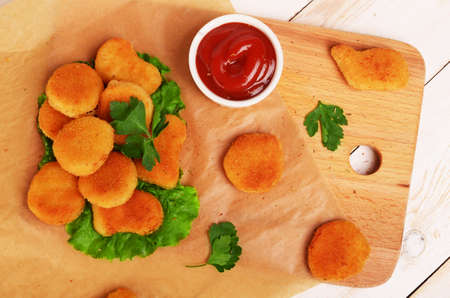 Chicken nuggets with ketchup on a wooden backgroundの写真素材