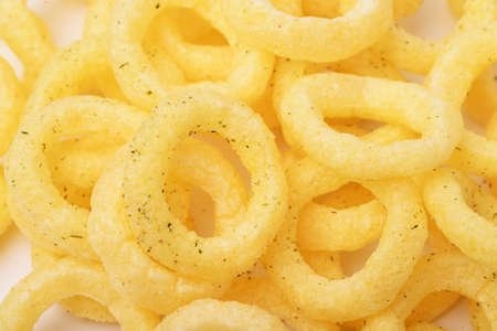 Pile of crispy onion rings close up as background