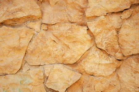 Old background orange stone wall close up, texture abstract