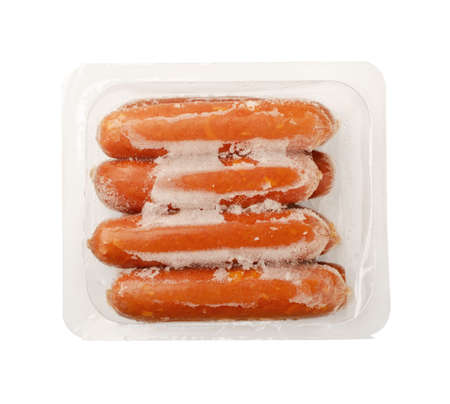 Sausages in vacuum packaging in ice isolated on a white background. A pack of sausages from a store isolated on a white background.の写真素材