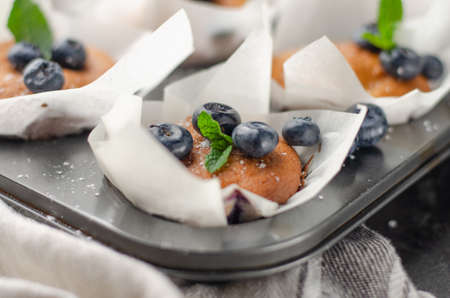 Blueberry homemade muffins with berries on a table