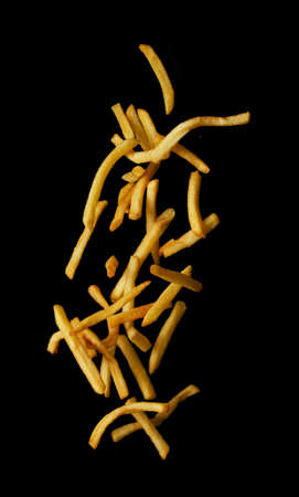 French fries flying in the air isolated on black background, Stop motionの写真素材