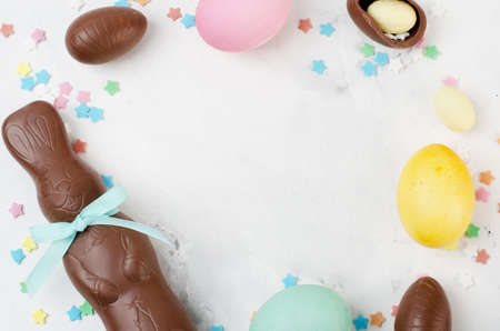 Chocolate easter rabbit and eggs on background, space for textの写真素材