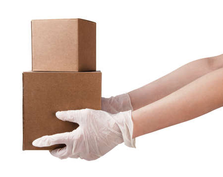 Courier with medical gloves delivers parcels during quarantine. Safe delivery service. Isolated in a white background.の写真素材
