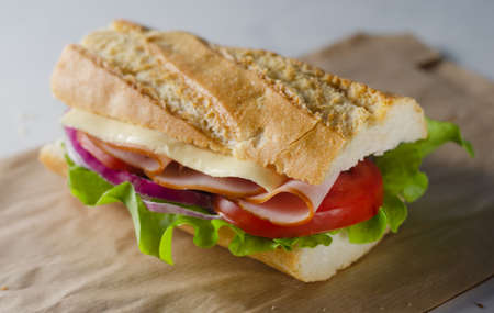 Fresh submarine sandwich with ham, cheese, tomatoes and lettuce