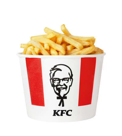 Moscow, Russia - July 16, 2020: A lots of KFC french fries in bucket of KFC (Kentucky Fried Chicken)...