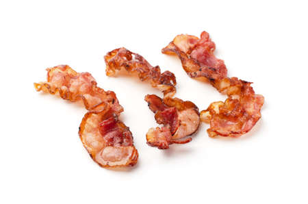 Cooked fried slices of bacon isolated on a white backgroundの写真素材