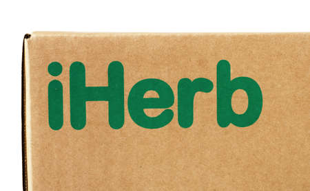 Russia Moscow, 13.07.2021: Box with the brand iHerb. Close-up isolated on a white background.のeditorial素材