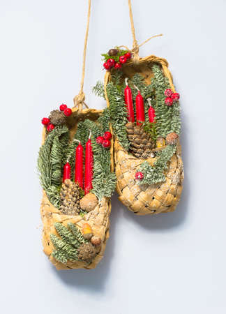 Russian Christmas decoration with bast shoes and candles