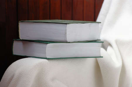 books on a white chairの写真素材