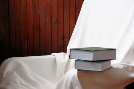 books on a white chairの写真素材