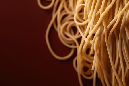 close up of uncooked italian spaghetti pasta on brown background with copy spaceの素材