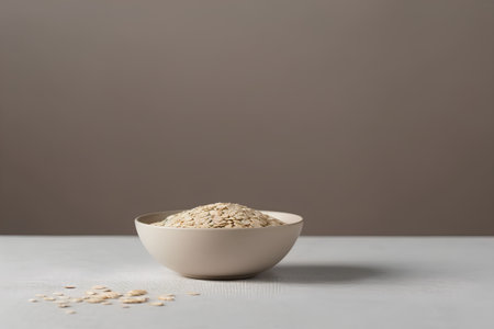oatmeal in a white bowl on a gray background, copy spaceの素材