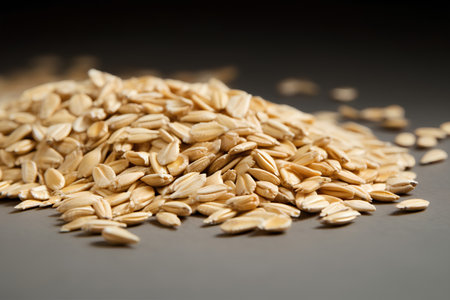 Pile of oat grains on black background. Close up.の素材