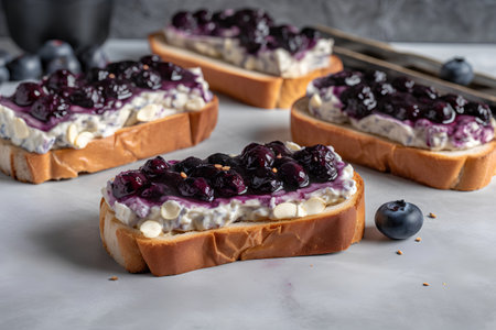 Sandwiches with cottage cheese, blueberries and currants on a gray backgroundの素材