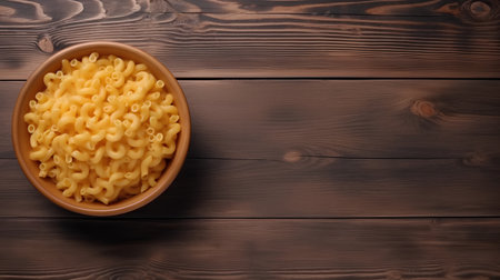 Pasta in bowl on wooden background. Top view with copy spaceの素材