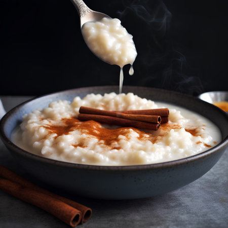 Rice porridge with cinnamon and honey in a bowl on a dark backgroundの素材