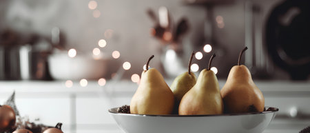 Pears in a bowl on a kitchen countertop with Christmas ornamentsの素材