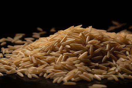closeup of a pile of uncooked rice on a black backgroundの素材