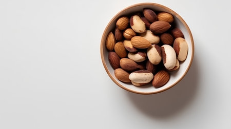 Mix nuts in a bowl on white background. Healthy food concept.の素材