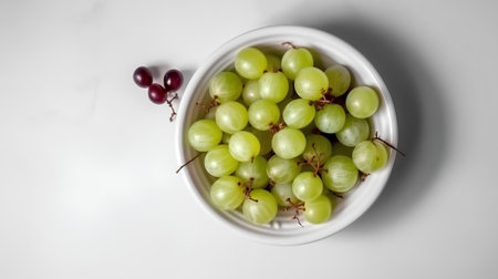 Grapes in a white bowl on a white background, top viewの素材